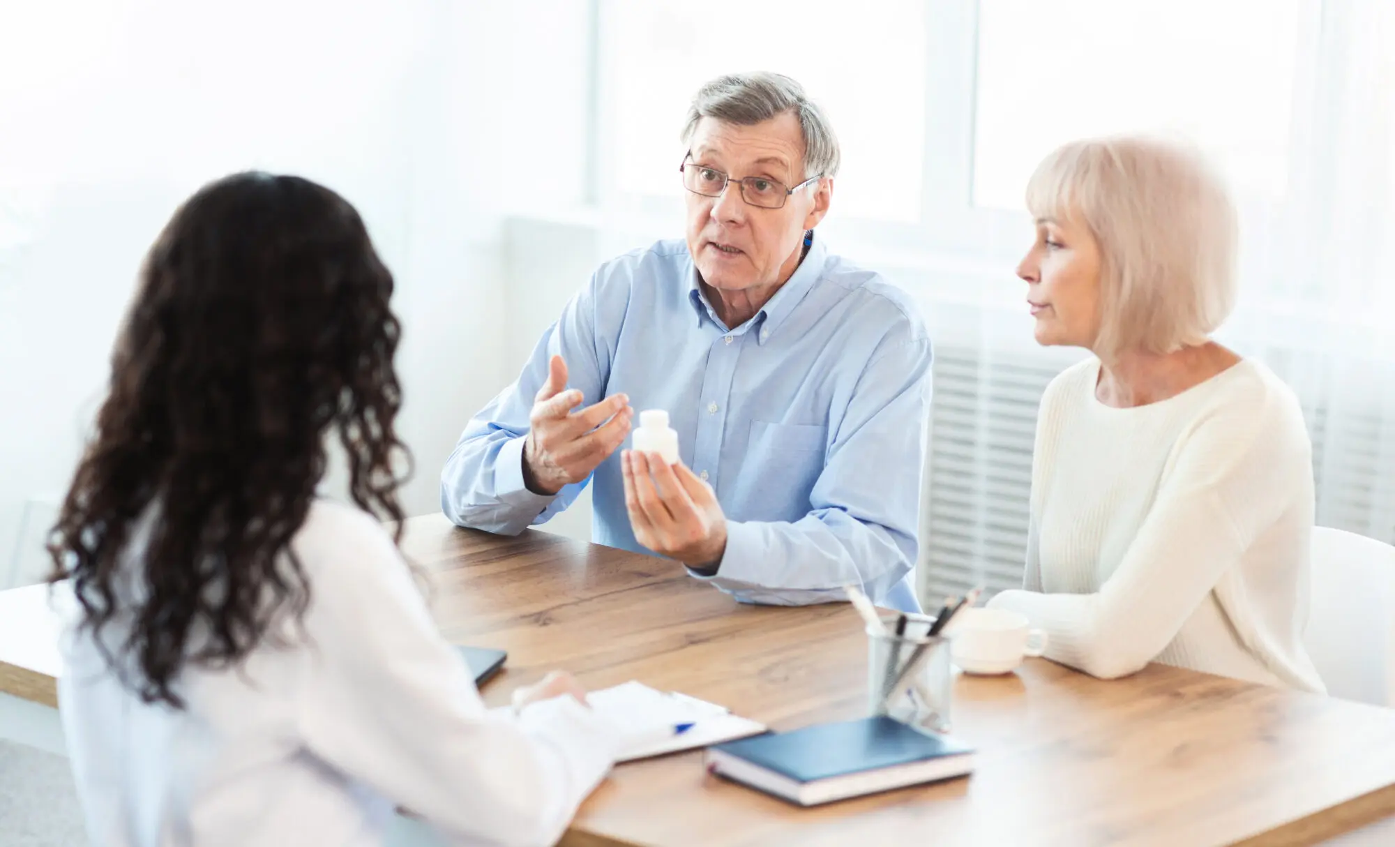 Older couple discussing medical treatment with their doctor