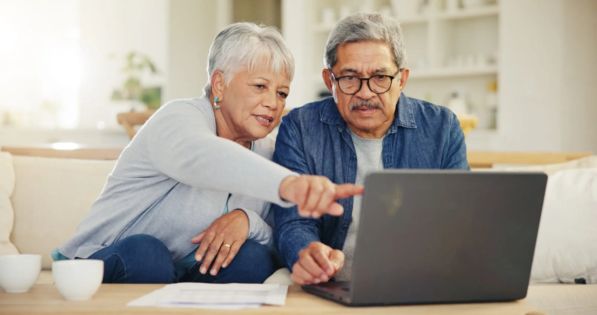 Older couple researching legal questions together on a laptop at home
